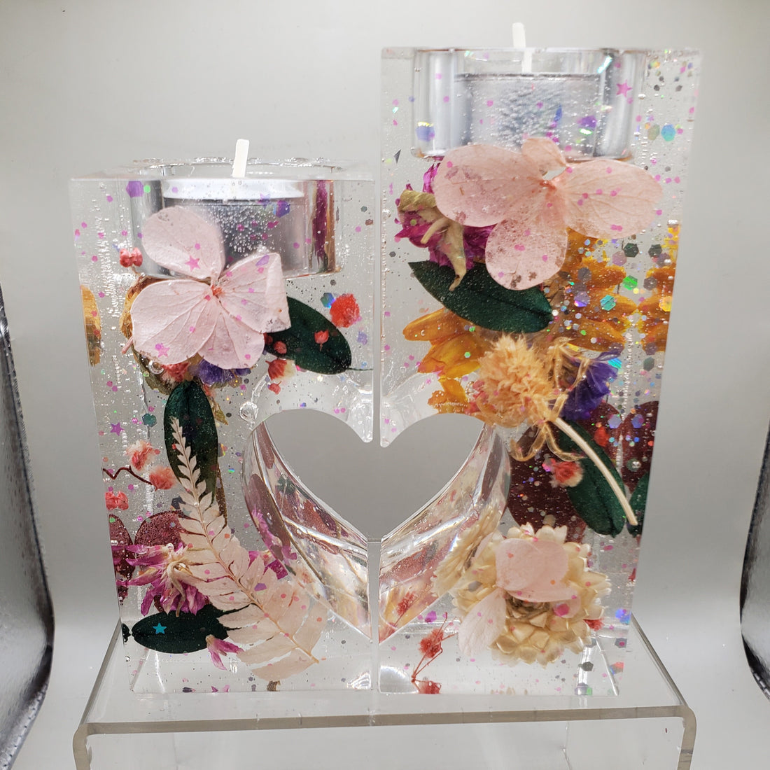 These resin candle holders feature delicate flowers and leaves. Perfect for adding a touch of elegance to any room.