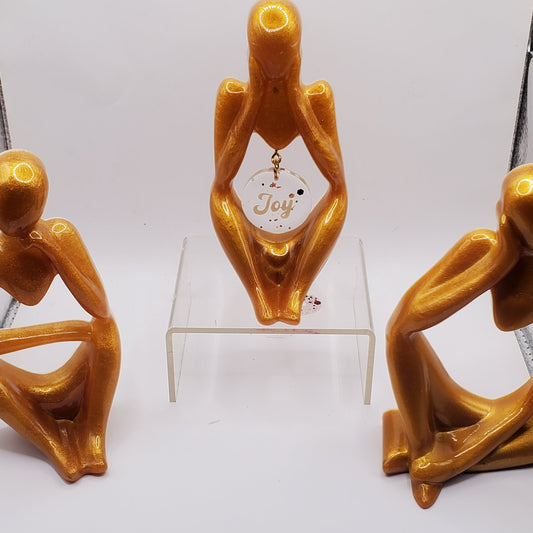 Three  statues adding a touch of sophistication to any space. Perfect home decor thinker statues.
