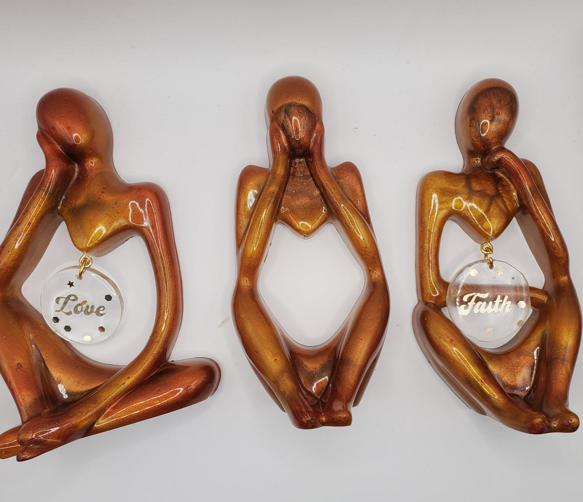 Three statues adding a touch of sophistication to any space. Perfect home decor thinker statues.